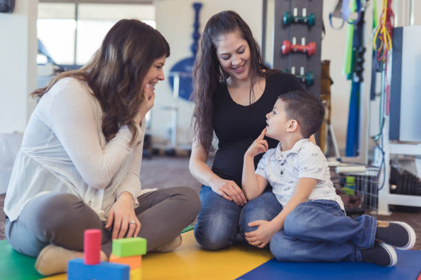 istock Speech therapist works with a young boy 1199808556