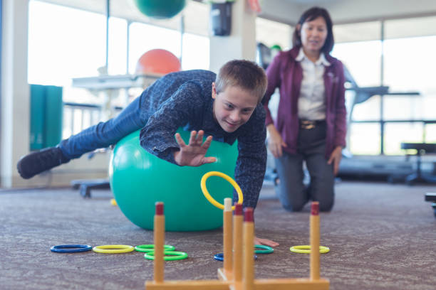 istock A boy does workouts with an occupational therapist at a physiotherapy clinic 1199808557