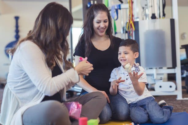 istock Speech therapist works with a young boy 1199808558
