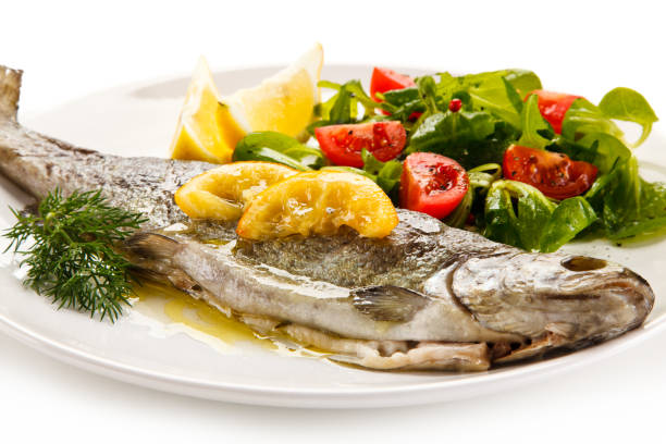 istock Roast trout and vegetables on white background 1199809243