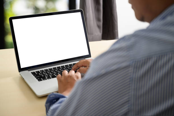 istock man working on his laptop with blank copy space Laptop with blank screen Mock up Blank screen computer 1199811380