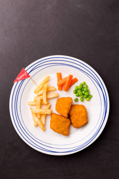 istock Kid's meal (dinner) - chicken nuggets, chips and green peas 1199811825