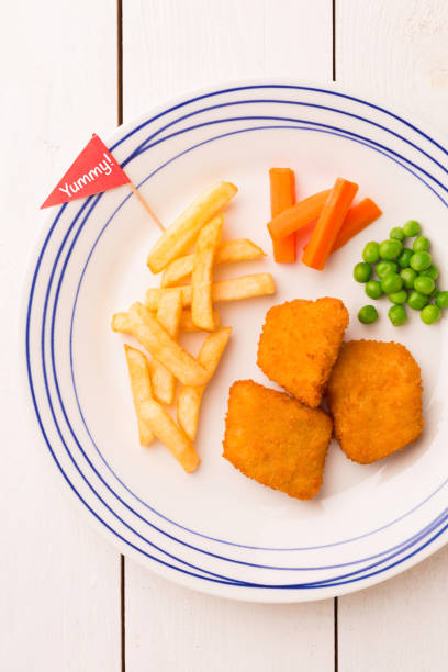 istock Kid's meal (dinner) - chicken nuggets, chips and green peas 1199811829