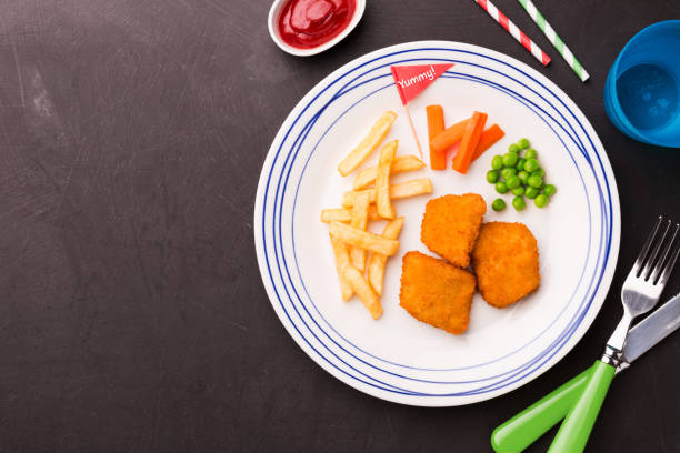 istock Kid's meal (dinner) - chicken nuggets, chips and green peas 1199811835