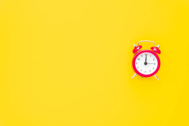istock Abstract creative flat lay vintage yellow table top view office background concept red clock on paper color in minimal style, Hot summer holiday time to break workplace at noon for lunch, Retro Hipster back to school vacation 1199811953