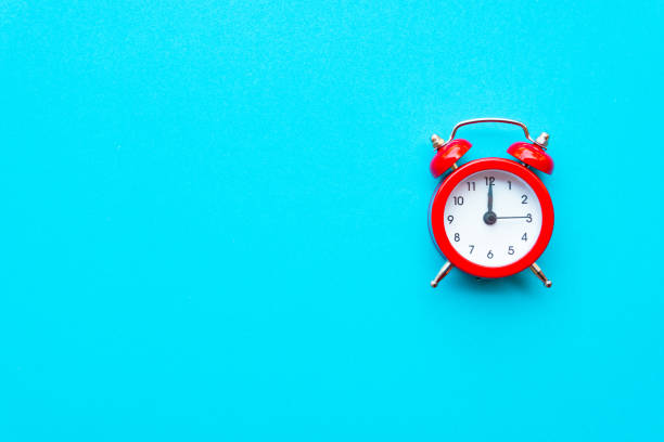 istock Abstract creative flat lay vintage blue table top view office background concept red clock on paper color in minimal style, Hot summer holiday time to break workplace at noon for lunch, Retro Hipster back to school vacation 1199811956