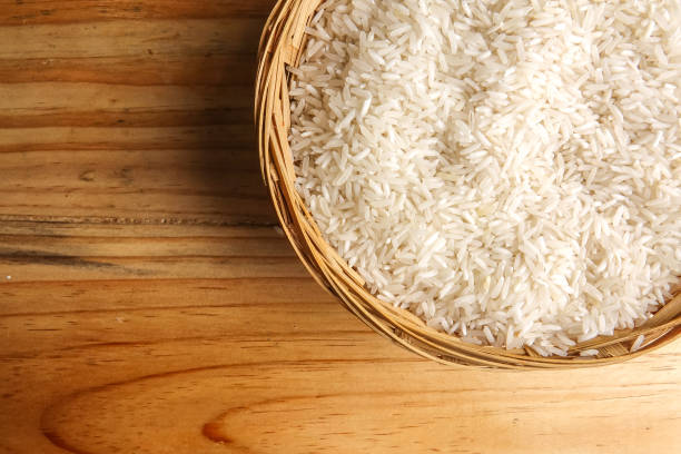 istock Fresh rice in wicker basket over a wooden table. Side lighting effect. 1199812469