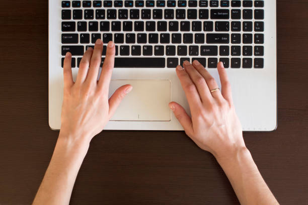 istock young woman typing on laptop 1199813011