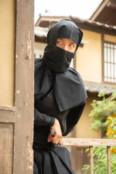 istock Japanese Ninja with Sword Planning Attack in Edo Period Village 1199813049