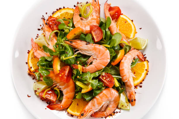 istock Seafood salad - shrimps and vegetables on white background 1199813257