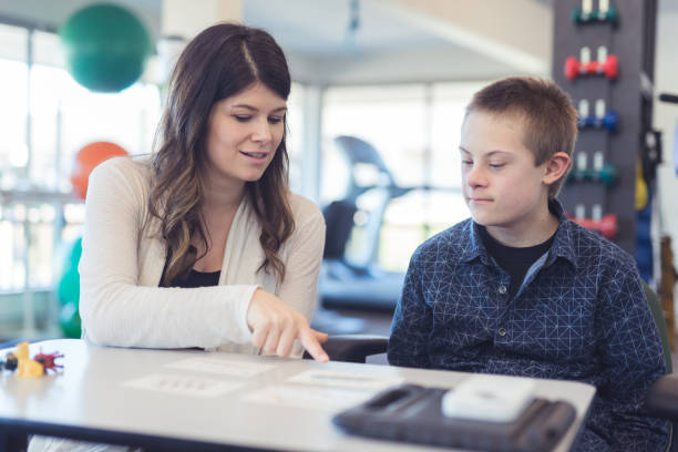 istock Speech therapist works with a young boy 1199815686