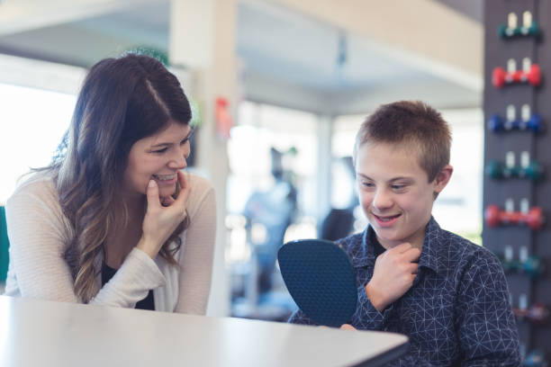 istock Speech therapist works with a young boy 1199815688