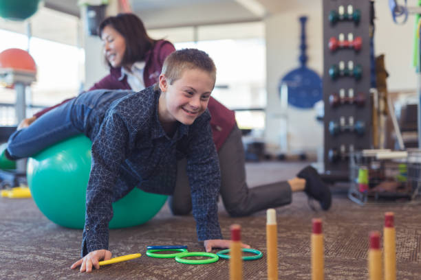 istock A boy does workouts with an occupational therapist at a physiotherapy clinic 1199815689