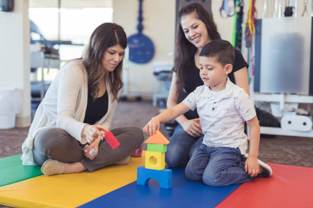 istock Speech therapist works with a young boy 1199815691