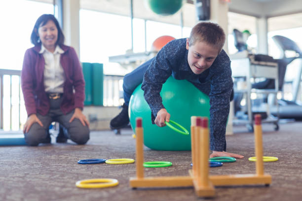 istock A boy does workouts with an occupational therapist at a physiotherapy clinic 1199815692