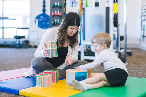 istock Young boy doing a fun building exercise with blocks in a physiotherapy clinic 1199815706