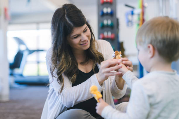 istock Physical therapist working with a young boy in the clinic 1199815708