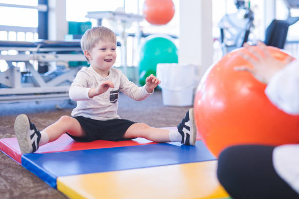 Young boy exercising in physiotherapy clinic
