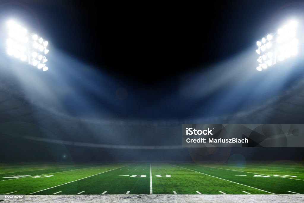 Football stadium American football field illuminated by stadium lights American Football - Sport Stock Photo