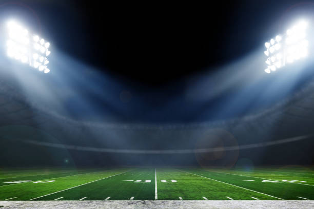 Football stadium American football field illuminated by stadium lights american football field photos stock pictures, royalty-free photos & images