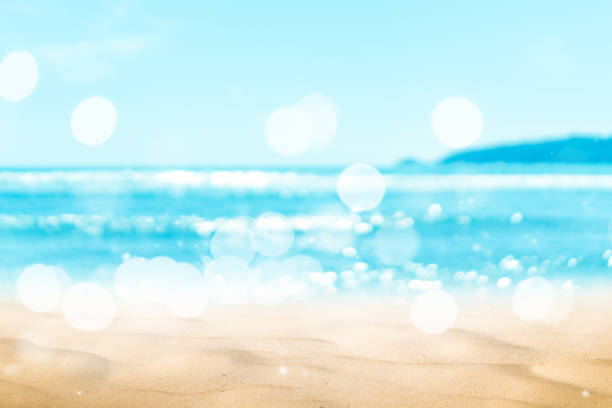 istock Copy space blur tropical beach with bokeh sun light wave on blue sky and white cloud abstract background. 1199817151