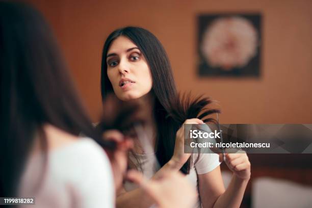 Woman Looking In Mirror Cutting Split Hair Ends Stock Photo - Download Image Now - Hair, Cutting, One Woman Only