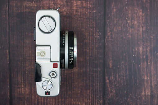 Flat lay of vintage camera on an old wooden background. Isolated background. Top view.