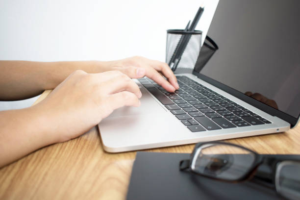 istock businessmen working on a computer desk on a wooden table. Close up. 1199826590