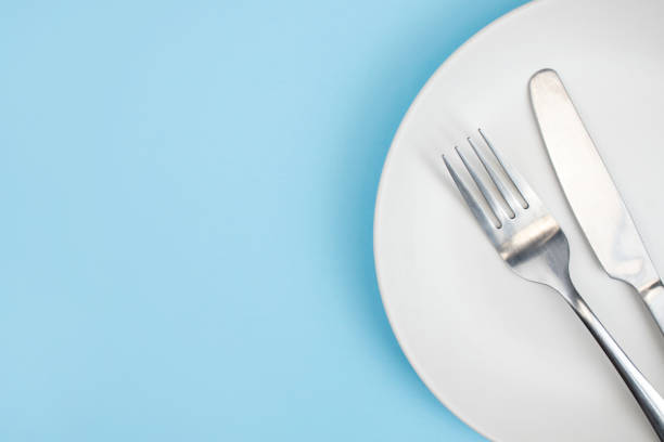 istock Top view plate with a spoon on the blue background. Close up. With copy space. 1199826669