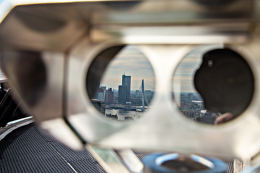 Aerial view of the Rotterdam skyline reflection in binoculars