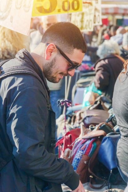 istock Boy from behind does shopping at the clothes market 1199839450