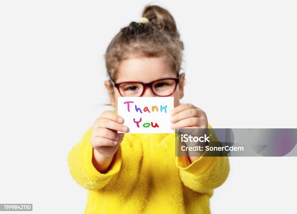 Adorable Baby Girl Is Holding A Paper With A Thank You Note Silent Communication Concept Stock Photo - Download Image Now