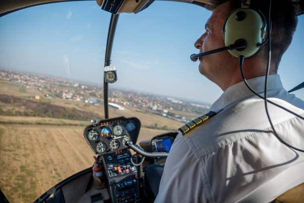 istock Pilot with headphones flying a helicopter 1199844043