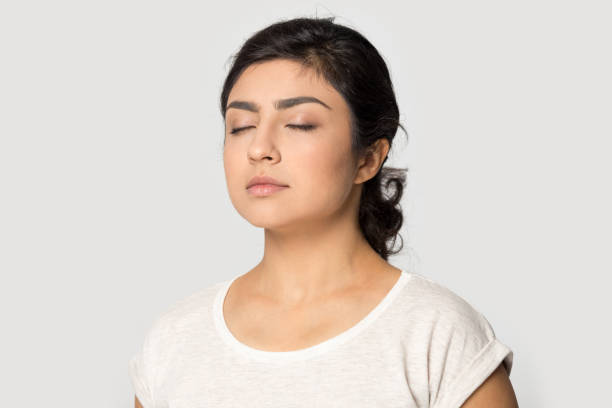 istock Half side view peaceful millennial indian girl meditating. 1199847369