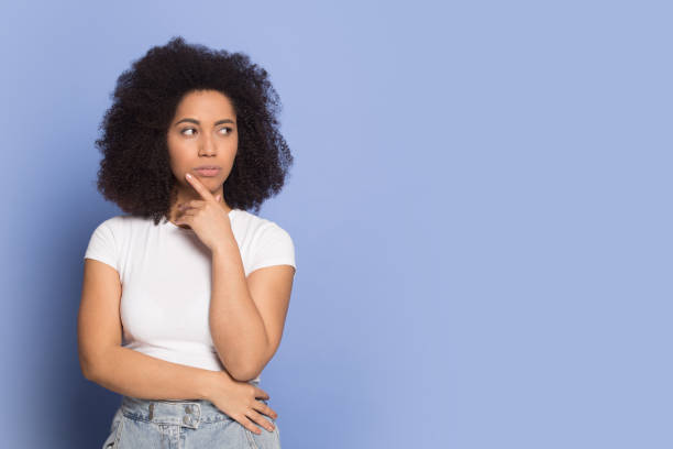 istock Doubtful african american young lady looking away on empty space. 1199848721