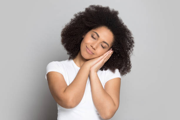 istock Tired african american millennial lady put head on folded hands. 1199848768