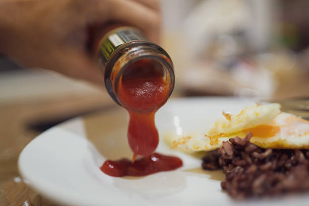 istock Pouring ketchup into a dish 1199848898