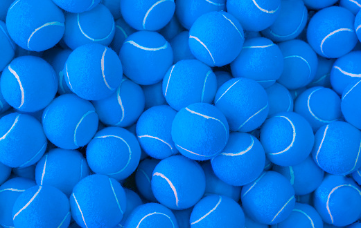 Lots of vibrant tennis balls, pattern of new blue tennis balls for background
