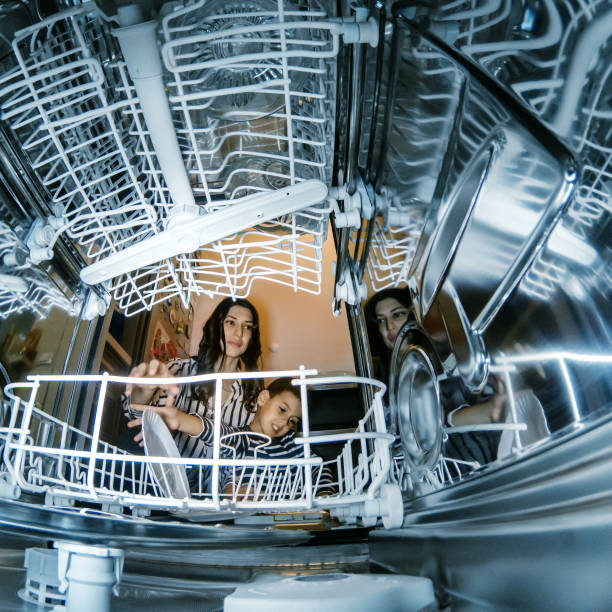 istock Woman using dishwasher in the kitchen 1199849252