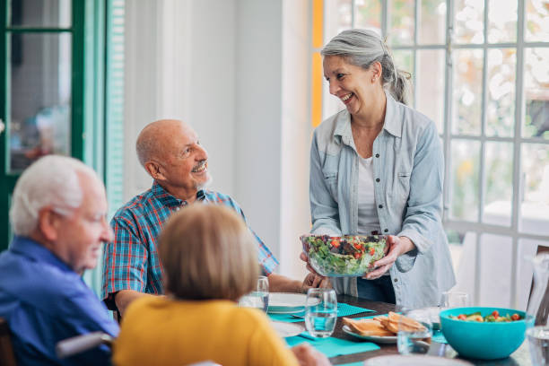 istock Senior friends having dinner together 1199850429