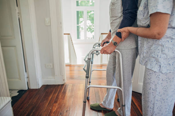 istock Senior wife helping her husband with mobility walker 1199854594