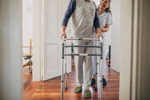 istock Senior wife helping her husband with mobility walker 1199854619