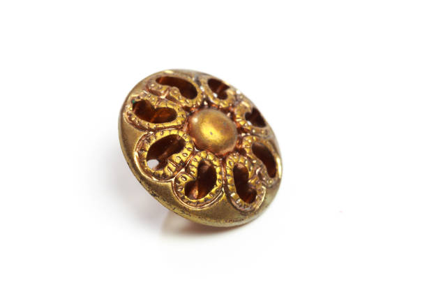 istock Vintage golden cloth button closeup on white background 1199855411