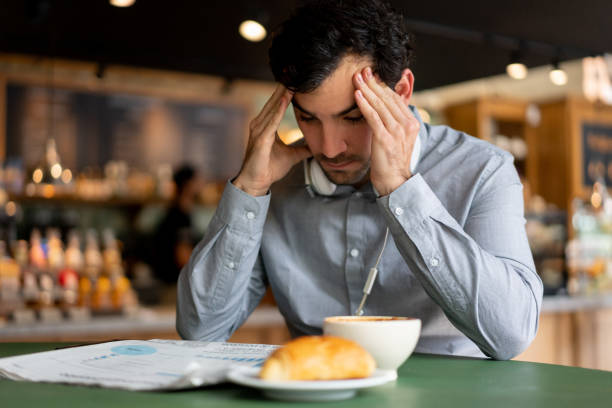 istock Upset man reading the newspaper at a cafe 1199858226