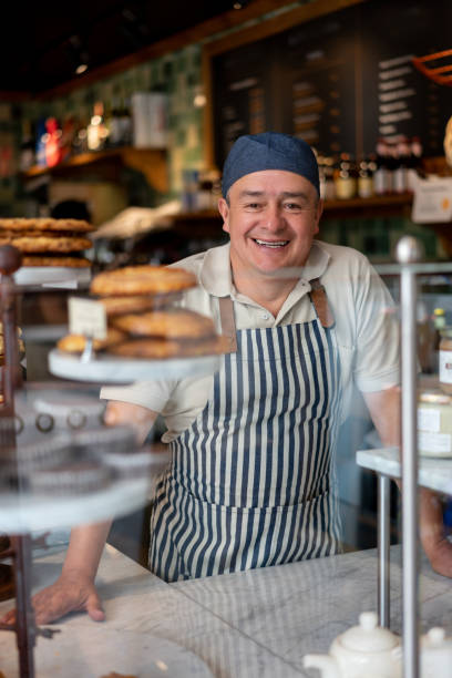 istock Happy man working at the bakery shop 1199858246