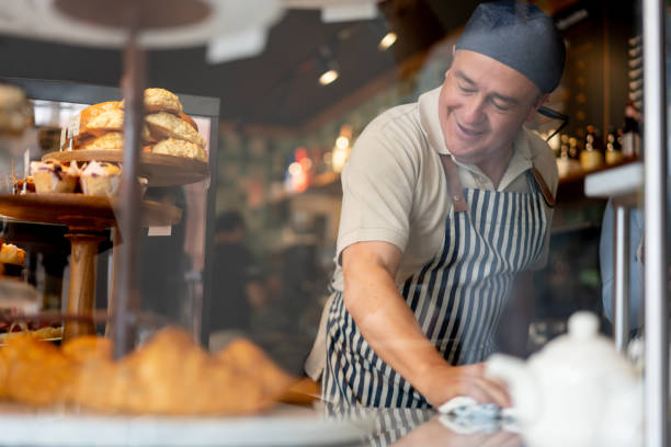 istock Happy man working at the bakery shop 1199858268