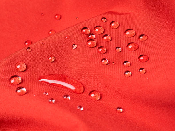 istock Red waterproof fabric with water drops closeup 1199861381