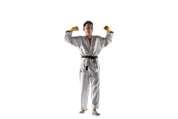 istock Confident korean man in kimono practicing hand-to-hand combat, martial arts 1199861489