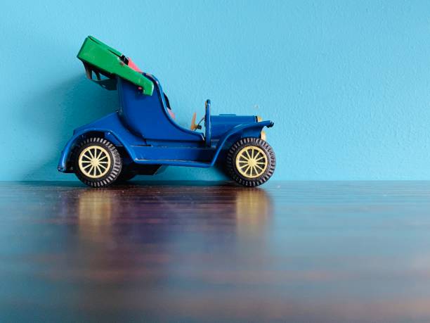 istock Vintage convertible toy car on blue background 1199864446