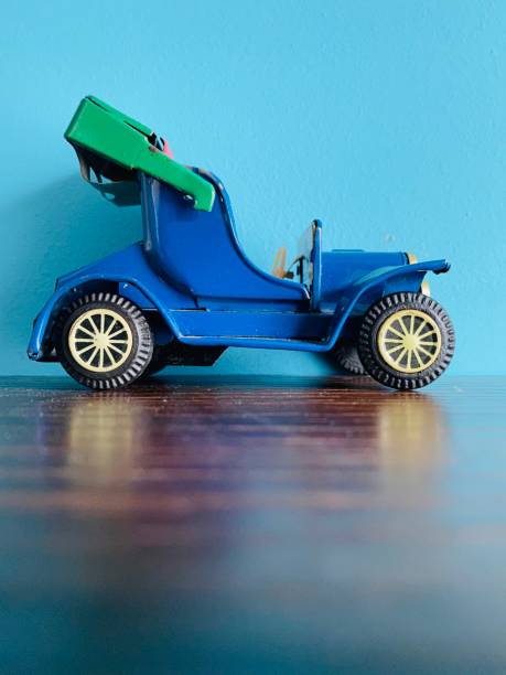 istock Vintage convertible toy car on blue background 1199864459